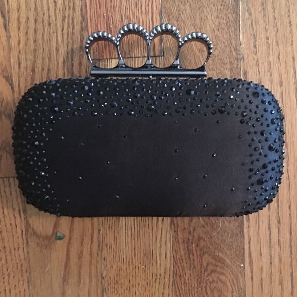 Black clutch with “brass knuckle” opener